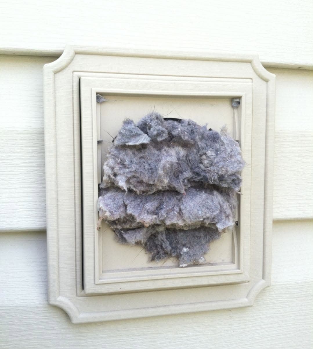 Lint-clogged exterior dryer vent before cleaning by JCS Home Services in Alexandria VA
